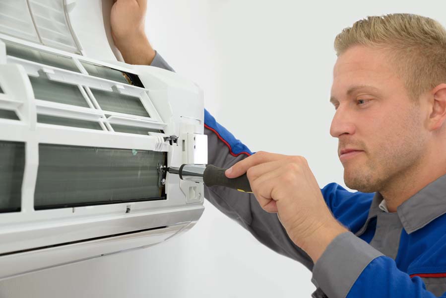 Technician Repairing Air Conditioner